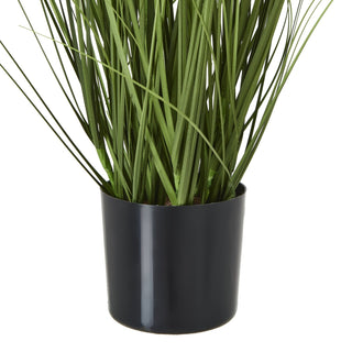 Close-up showing the glossy black cylindrical pot and the base of the artificial grass.