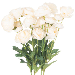 Bunch of artificial cream ranunculus flowers with green stems and leaves, shown against a white background.