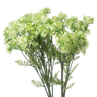 Artificial spray featuring clusters of pale lime green flowers and buds on dark green stems and fern-like leaves.