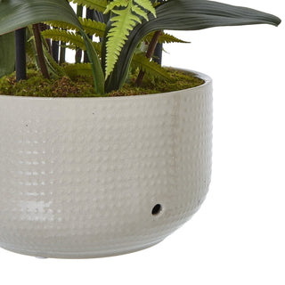 Close detail of the light grey ceramic pot showing its crackle glaze finish and dimpled texture.