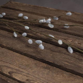 Close detail of the artificial pussy willow catkins showing their fuzzy white and grey texture.