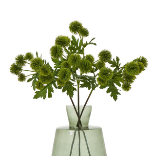 Artificial green thistle spray stems displayed upright in a pale green glass vase.
