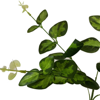 Close detail of the artificial spray showing the mottled dark and light green variegation on the rounded leaves.