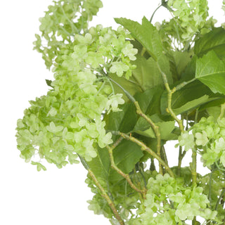 Close-up detail of the artificial light green viburnum flower clusters, dark leaves, and textured stems.