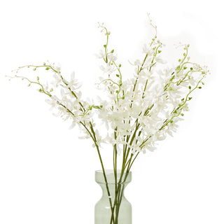 Full arrangement of several white artificial cymbidium sprays in a pale green vase.