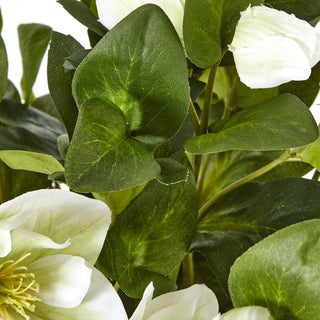 Detail shot of the artificial plant showing textured green leaves and white petals.