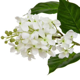 Detailed view of the artificial white lilac flowers and green buds against a white background.
