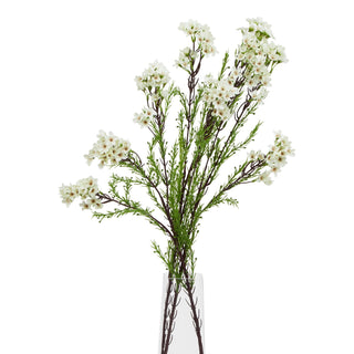 Plain front-on view of the artificial white waxflower stem in a clear glass vase.
