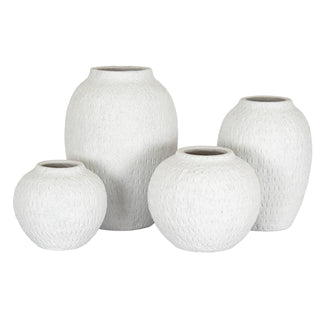 The large tall white vase displayed with three other matching vases in different shapes and sizes.