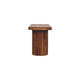 End view of the dark wood bench, highlighting the seat thickness and cylindrical fluted support.