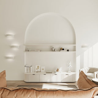 Three ceramic wall lights stacked vertically on the left wall, plus one on the right, in a minimalist, neutral interior.