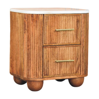 Close view showing the reeded wood texture, white marble top, and rounded wooden feet.