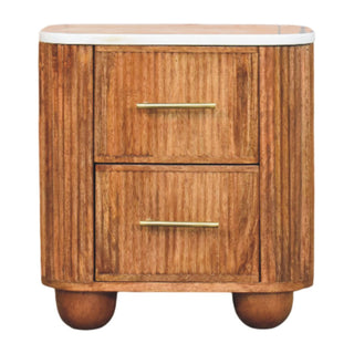 Wooden bedside cabinet with a marble top, two drawers, brass handles, curved reeded panelling, and bun feet.