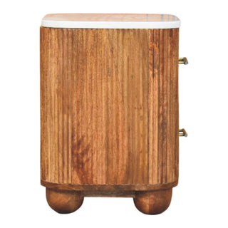 Side view of the reeded wood bedside cabinet showing the texture and rounded profile.