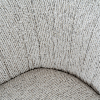 Close-up of the curved seam where the armchair seat meets the backrest, showing the vertical texture of the mist fabric.