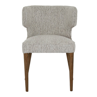 Upholstered dining chair with winged backrest, defined seat cushion, and two visible tapered wooden front legs.
