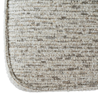 Close-up of the chair's light, woven, textured fabric showing the detail of the stitched edge.