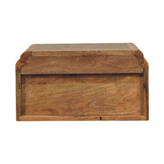 Front view of the wooden bedside unit, highlighting the grain, open storage shelf, and single drawer panel.
