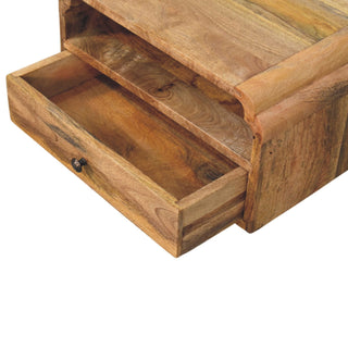 Close-up showing the wooden bedside unit with the single drawer fully open, revealing the interior storage space and metal knob.