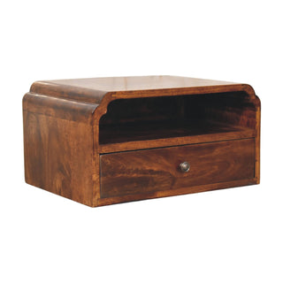 Three-quarter view of the chestnut bedside unit showing the curved top edge and wood grain.