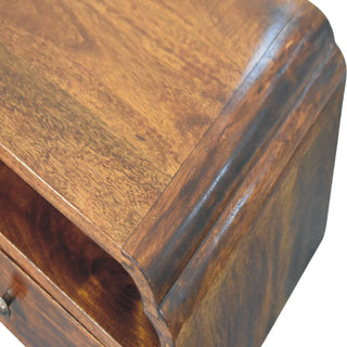 Close detail of the chestnut bedside unit's top surface and the dark, moulded edge profile.