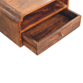 Close-up of the chestnut bedside unit with the drawer pulled out, showing the interior storage space.