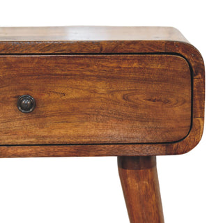 Close-up showing the rich chestnut wood grain, rounded drawer edge, and dark circular handle.