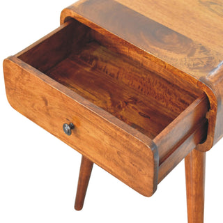 Close-up of the chestnut nightstand with the drawer open, showing the interior storage space and wood grain.