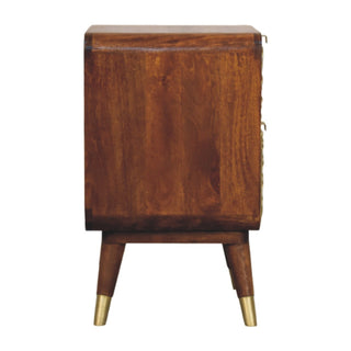 Side view of the chestnut nightstand, showing the depth, smooth wood panel, and tapered legs with brass tips.