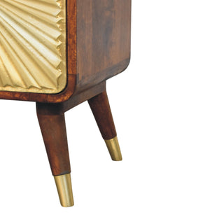 Detail of the tapered chestnut legs finished with brass tips below the rounded wood frame.