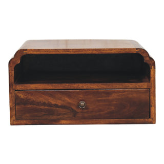 Front view of the chestnut wooden wall-mounted bedside unit. It has one open storage shelf and a single drawer with a round metal handle.