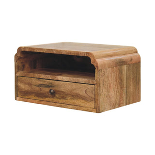 Angled view of the wooden bedside unit, highlighting the rich grain, single drawer, and curved top edge profile.