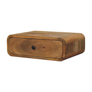 Three-quarter view of the wooden nightstand, highlighting the rounded edges and varied wood grain.