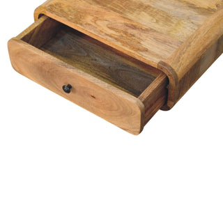 Close-up of the wooden nightstand with the single drawer pulled open, showing the interior depth and dark metal knob.
