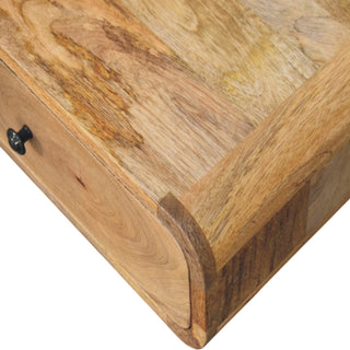 Close-up detail of the rounded front corner, showing the varied wood grain and construction joint.