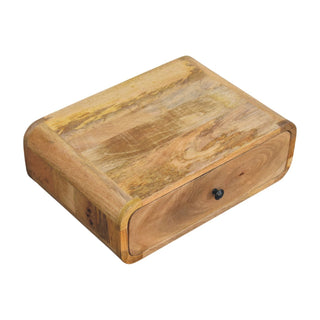 Top-down view of the wooden nightstand, showing the rounded edges and the single drawer with a dark metal pull.