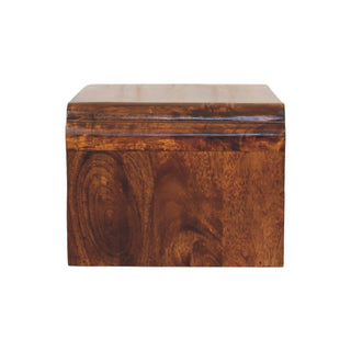Side view of the chestnut bedside unit showing the vertical wood grain and curved top edge.