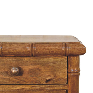 Detail shot showing the amber oak tabletop, bamboo-effect frame corner, and the wood grain texture.