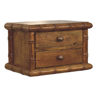 Detail of the bamboo-effect frame and amber oak drawers with round antique brass-style knobs.