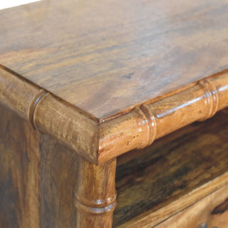 Detailed view of the amber oak finish on the tabletop, showing the wood grain texture and corner joint.