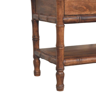 Detail showing the lower shelf support and the bamboo-style turned wooden legs.