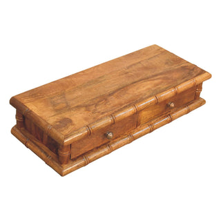A high-angle view of the wall console showing the rich wood grain, two drawers, and faux bamboo trim.