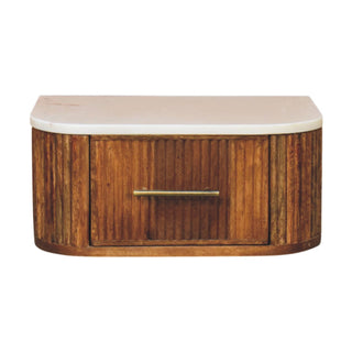 Front-on view of the wooden wall-mounted bedside unit with fluted texture, marble top, and brass handle.