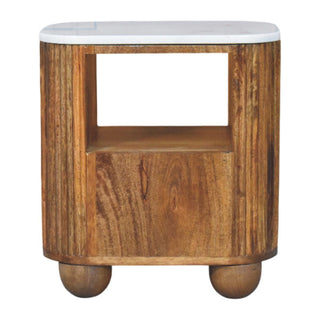 Rounded bedside table featuring a white marble top, open storage compartment, lower drawer, and two wooden bun feet.