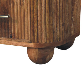 Close up of the reeded wood body meeting the rounded wooden bun foot at the base of the bedside.