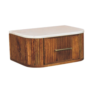 Studio shot of the wall-mounted bedside unit, showing the white marble top and curved fluted wood body.