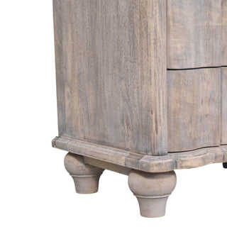 Detail shot of the distressed grey nightstand showing the turned bun feet and curved base moulding.