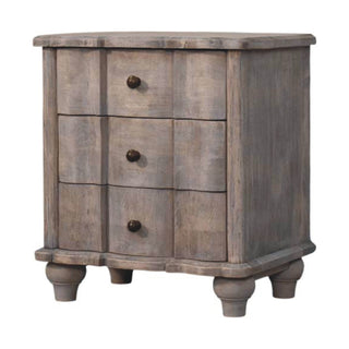 Plain front-on shot of the grey distressed wooden nightstand. Features three curved drawers, dark knobs, and turned feet.