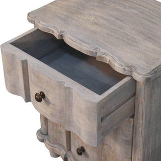 Close-up of the distressed grey nightstand with the top curved drawer pulled open, showing the drawer interior.