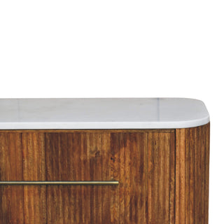 Close-up of the rounded corner showing the white marble top and vertical wood panelling detail.